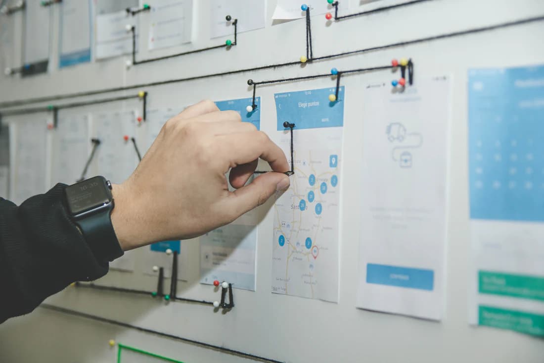 Wireframes pinned across a studio wall