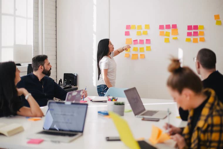 A workshop wall covered in coloured sticky notes