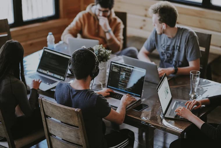 A team working together around a long wooden table