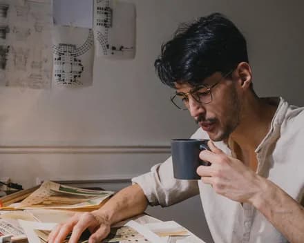 One of the studio's two architects reading material samples at the drawing table