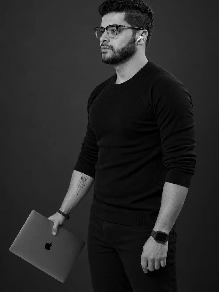 Studio portrait, laptop in hand